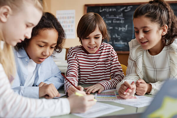 Photo of students having purposeful discussions in the classroom.