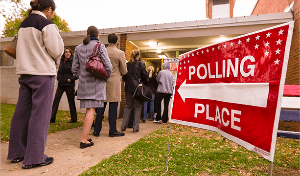 People practicing their civic responsibility by standing in line to vote in an election.
