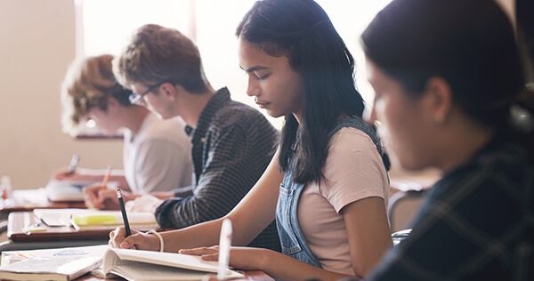 High school students in Spanish class writing down Can-Do Statements to help monitor their progress of Spanish-language acquisition.