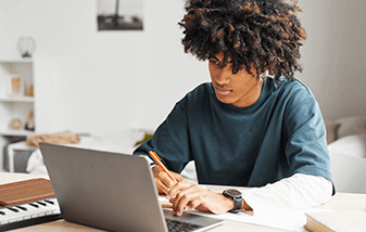 01-male-student-doing-work-on-laptop-337x214.png
