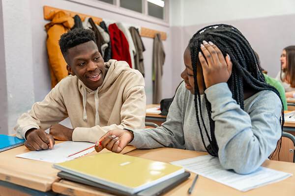 Two middle school students exploring fun phonics activities in partners.