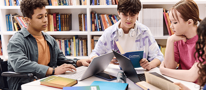 high-school-students-studying-working-in-library-on-laptops-705x310.png