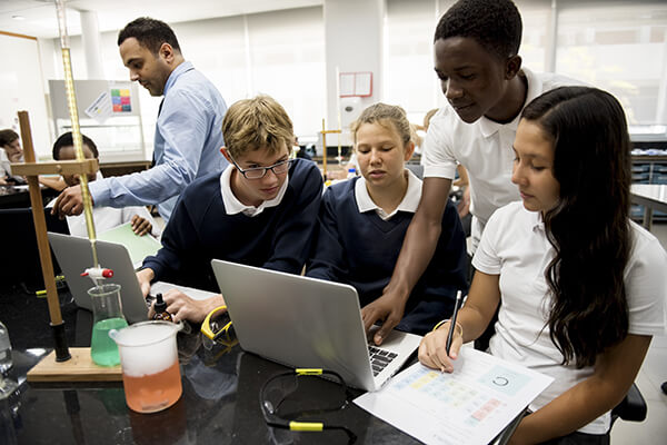 A group of high school students conduct a three-dimensional experiment in a science laboratory.