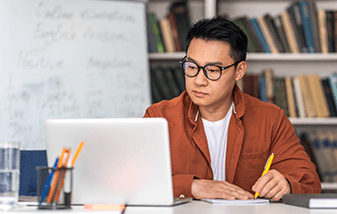 04-male-teacher-planning-on-laptop-337x214.png